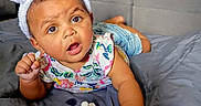 Sa'Riah is registered to the contest to win money with this photo: baby, bunny_ears, pacifier, bed, blanket, child, curious, expression, face, headwear, indoor, infant, laying_down, person, plush, purple, shirt, shorts, toy, young_child
