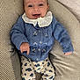 baby, smiling, blue_sweater, floral_pants, striped_cushion, infant, happy, cozy, knitted_clothing, cute, portrait, indoors, person, child, seated, plush, comfortable, closeup, baby_clothes, soft_fabric