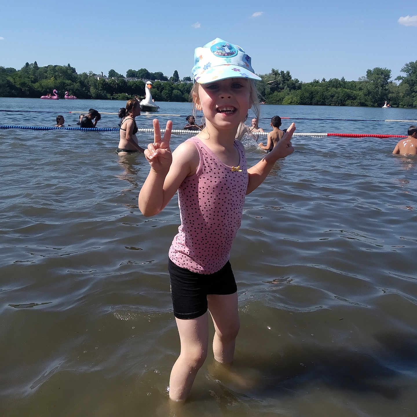 Ambre a rejoint le concours — aidez-le/la à gagner de superbes lots ! cap, child, float, fun, girl, happy, inflatable, lake, nature, outdoor, peace_sign, people, recreation, shorts, summer, sunny, swimming, tank_top, trees, water