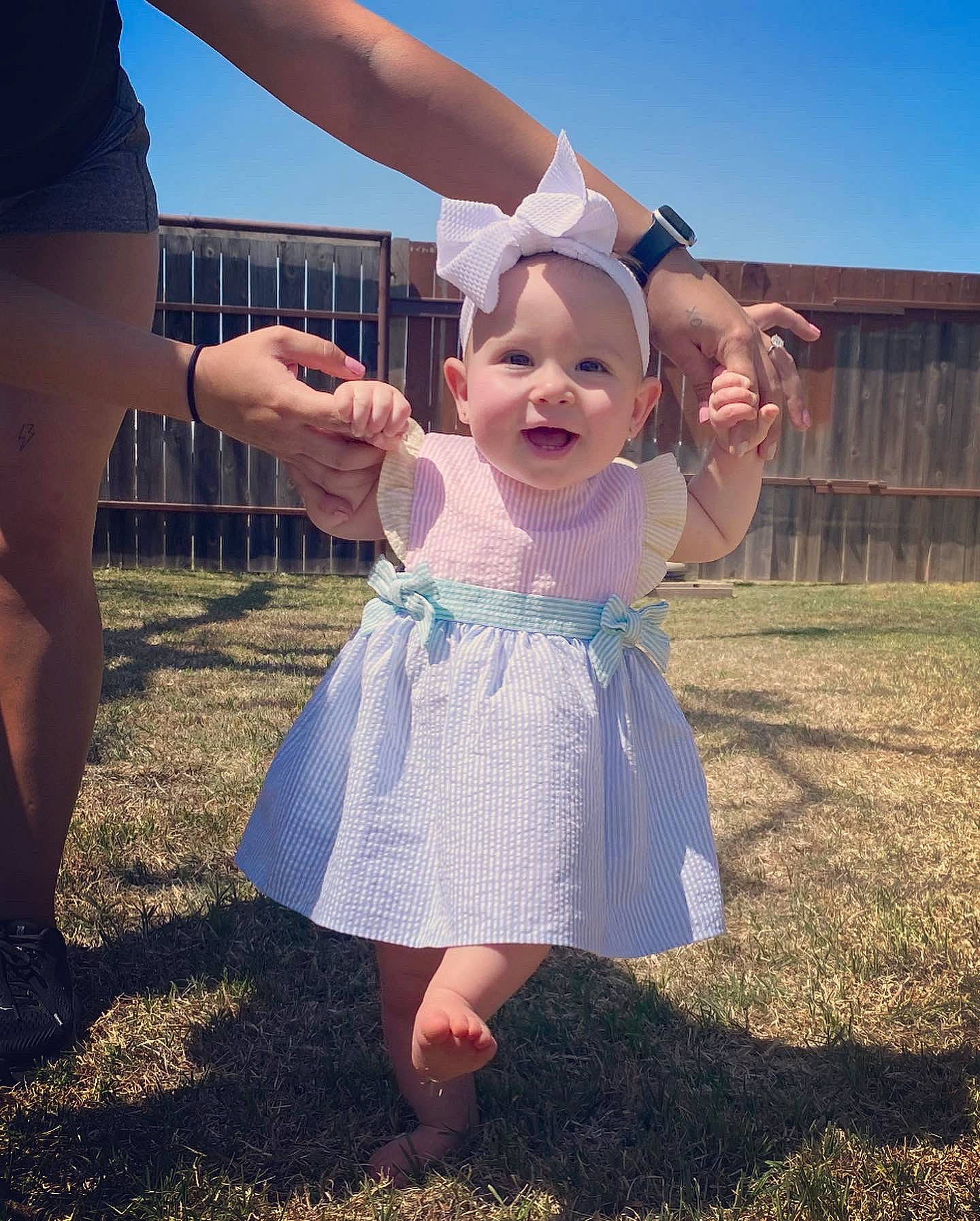 Navy joined the competition — help win amazing prizes! arm, baby_toddler_clothing, dress, finger, flash_photography, fun, gesture, grass, hand, happy, natural_environment, people_in_nature, person, pink, shoulder, skin, sky, sleeve, smile, standing