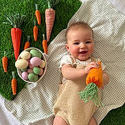 Kristina joined the competition — help win amazing prizes! baby, blanket, carrot, child, cute, decor, easter, eggs, fabric, green, happy, indoors, lying_down, orange, pastel_colors, playful, portrait, smiling, soft_texture, toy