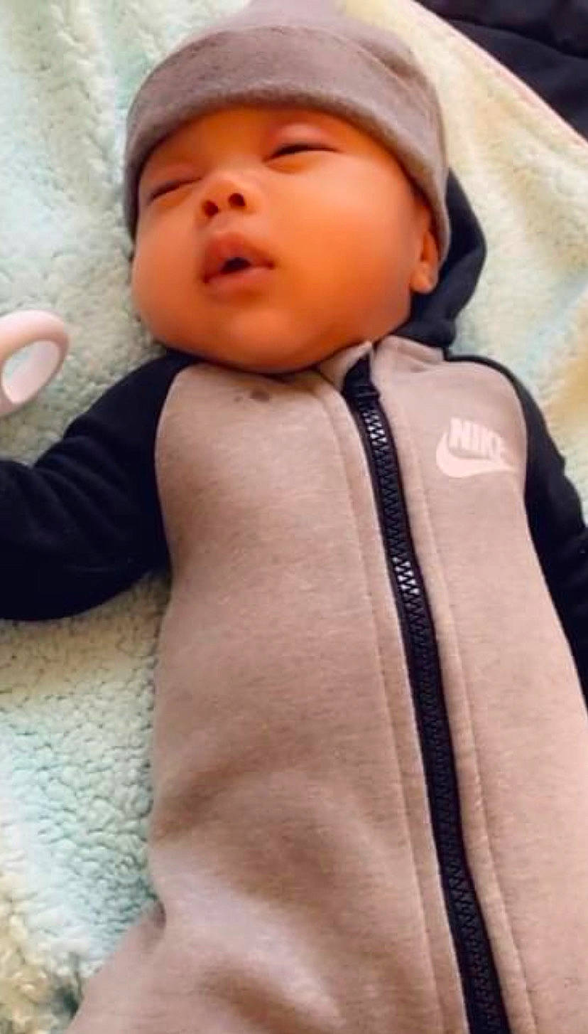 Kayden is registered to the contest to win money with this photo: baby, baby_toddler_clothing, cap, cheek, child, collar, comfort, face, fashion_accessory, finger, formal_wear, fur, headwear, hood, linens, lip, nose, person, skin, sleeve