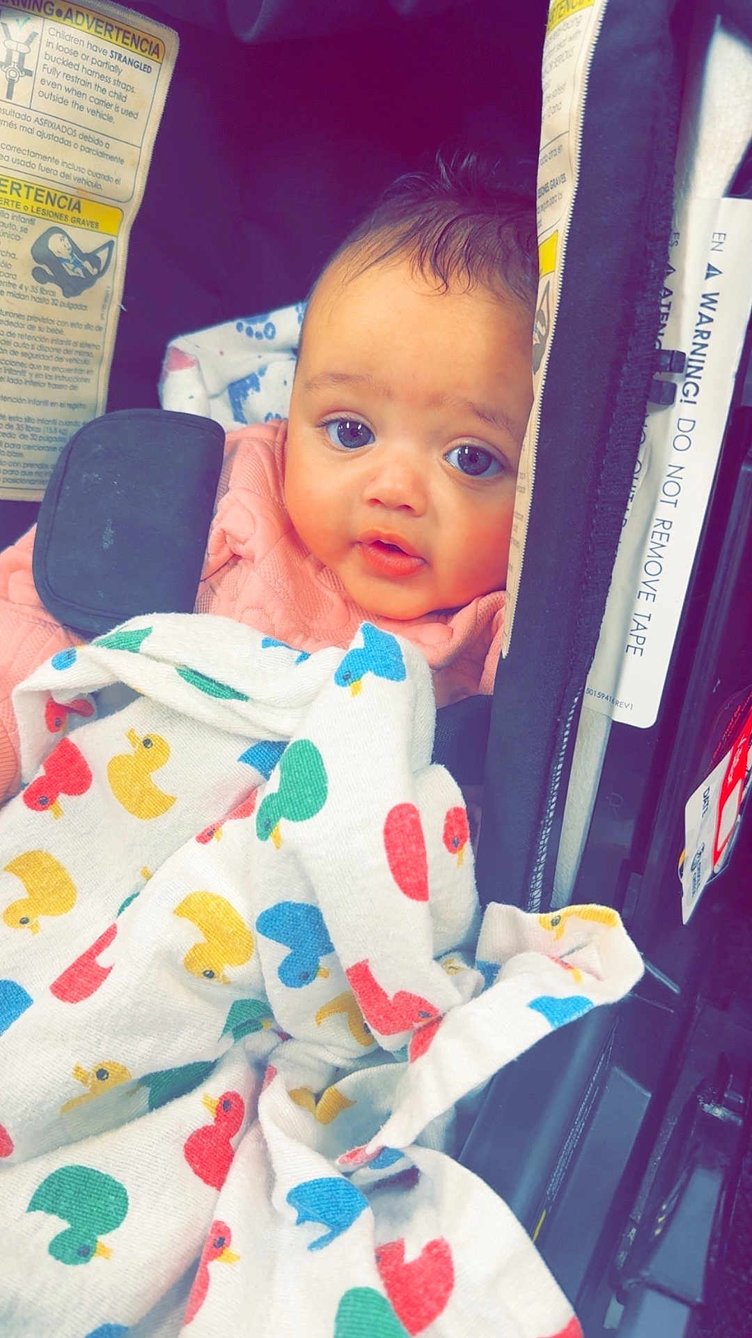 Saroya joined the competition — help win amazing prizes! baby, child, car_seat, blanket, duck_pattern, face, blue_eyes, pink_clothing, infant, cute, indoor, seatbelt, safety_warning, portrait, closeup, baby_blanket, expression, child_seat, young_child, comfort