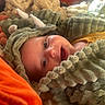 baby, child, costume, dinosaur, fuzzy, blanket, smile, face, head, happy, infant, cute, warm, cozy, soft, pillow, indoor, portrait, clothing, expression