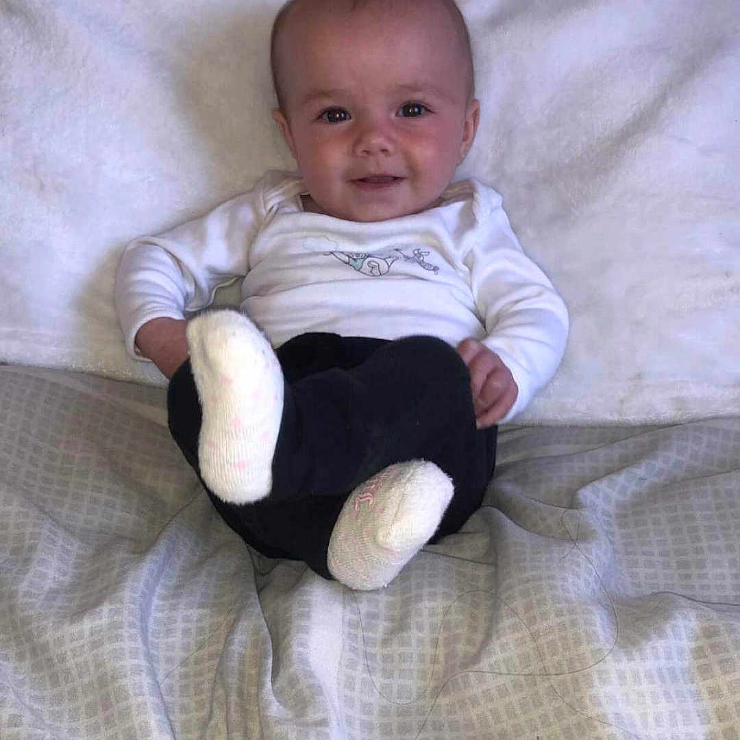 Mya Rose is registered to the contest to win money with this photo: baby, bed, bedroom, blanket, clothing, couch, cushion, face, furniture, head, homedecor, hosiery, indoors, newborn, pants, person, photography, portrait, room, sock