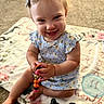 baby, child, smiling, sitting, toy, beads, blanket, carpet, indoor, cute, girl, hair_bow, blue_dress, floral_pattern, happy, portrait, infant, playful, toddler, closeup