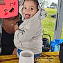 éden participe au concours pour gagner de l'argent avec cette photo : baby, child, clothing, cute, expression, fabric, face, greenery, happy, holding, hoodie, joy, outdoor, park, pattern, person, smiling, table, toddler, umbrella