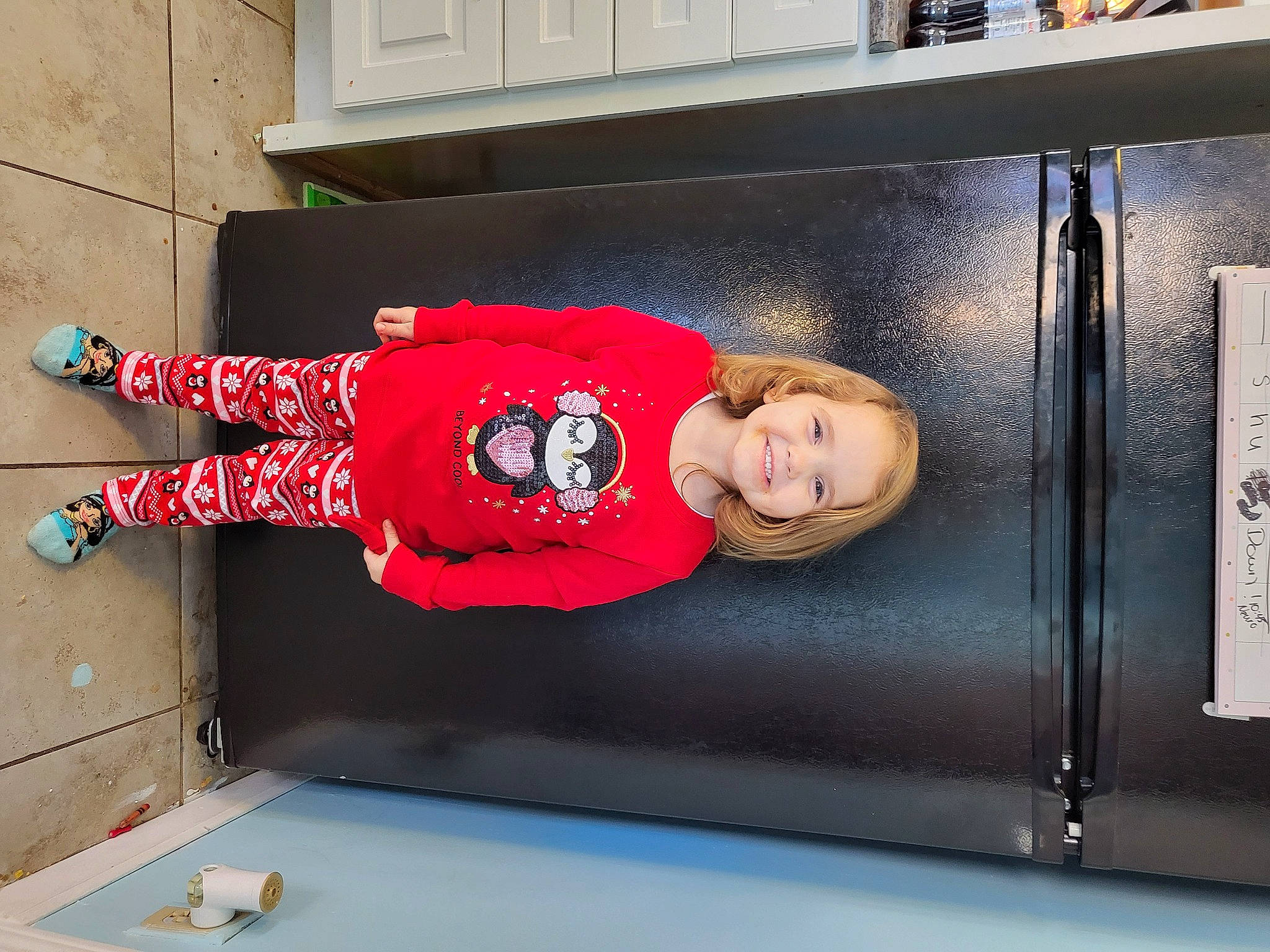 Ava is registered to the contest to win money with this photo: automotive_exterior, carmine, child, flooring, fun, human_leg, joy, leisure, pattern, person, rectangle, sidewalk, sleeve, smile, t_shirt, toddler, vehicle_door