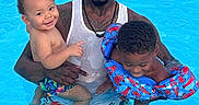 Terrance joined the competition — help win amazing prizes! baby, child, clothing, dreadlocks, family, floaties, fun, happy, man, outdoor, parent, people, pool, smile, summer, swimming, swimwear, tank_top, toddler, water