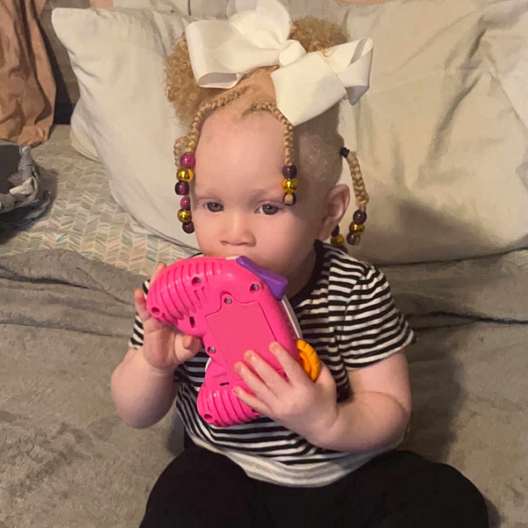 Lelani joined the competition — help win amazing prizes! baby, baseball, baseballglove, clothing, couch, cushion, face, footwear, furniture, glove, head, homedecor, pants, person, photography, portrait, sandal, shoe, sport, toy