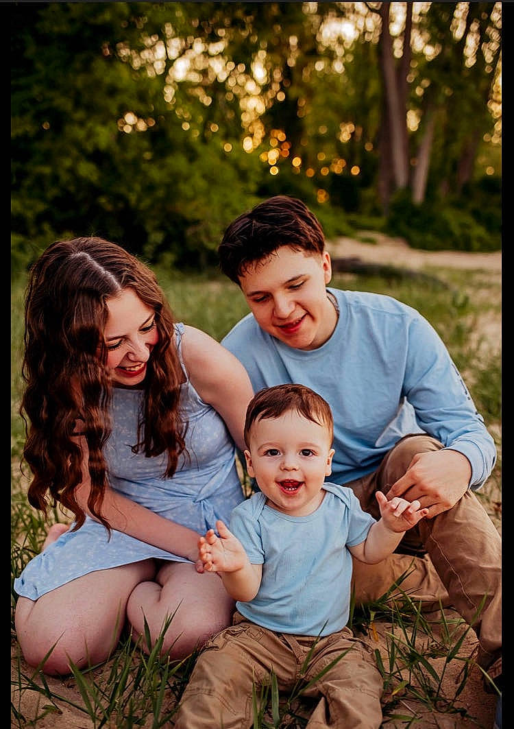 Emilio is registered to the contest to win money with this photo: face, facial_expression, flash_photography, fun, gesture, grass, hair, happy, human, interaction, joy, leaf, leisure, people, people_in_nature, person, plant, shorts, smile, summer