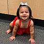 toddler, child, crawling, red_dress, white_bow, smiling, carpet, floor, indoor, cabinet, furniture, young_child, cute, happy, person, portrait, baby, skin, hair, hands