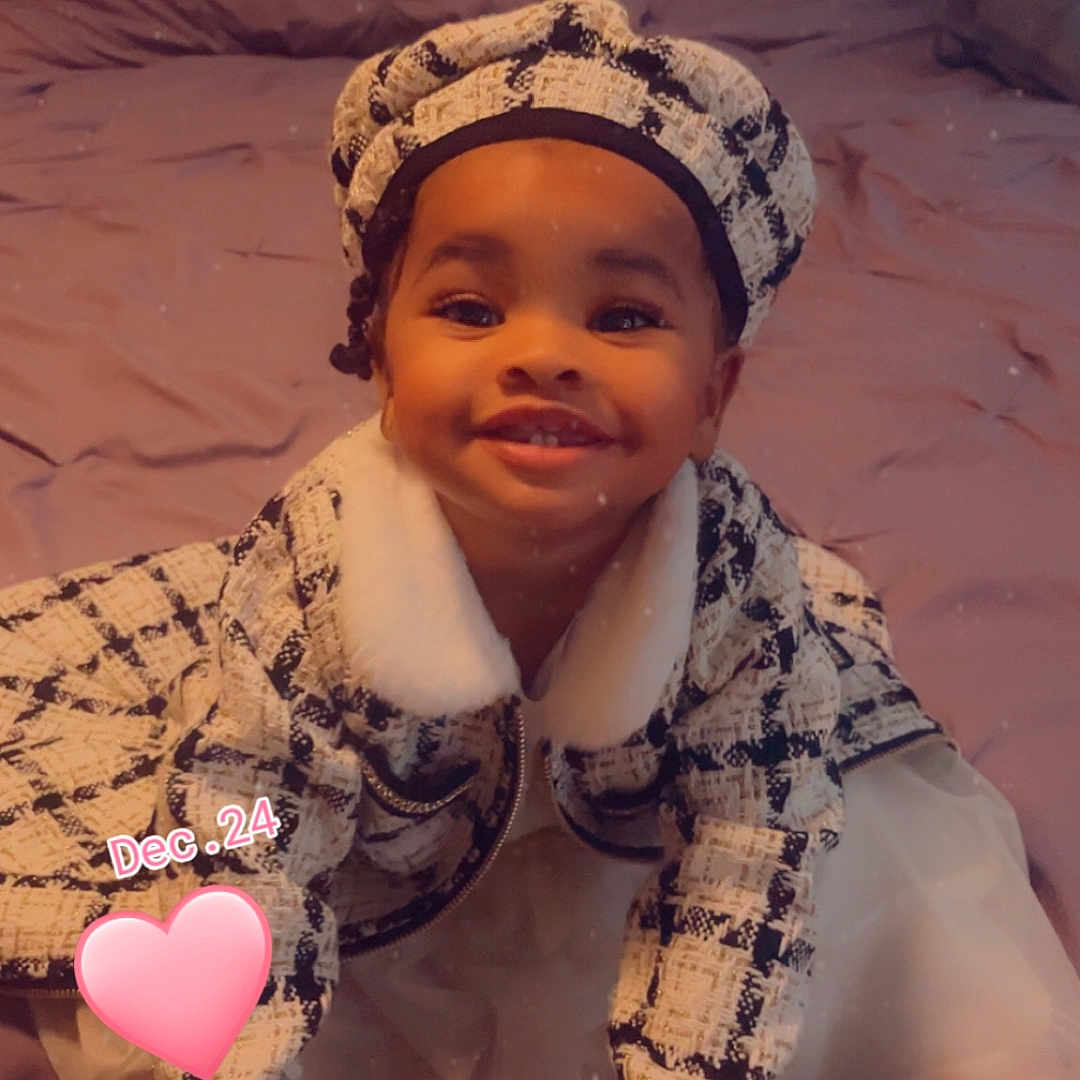Reemani joined the competition — help win amazing prizes! baby, balloon, bodypart, bonnet, cap, clothing, couch, face, finger, furniture, glove, hand, happy, hat, head, person, photography, portrait, sitting, smile