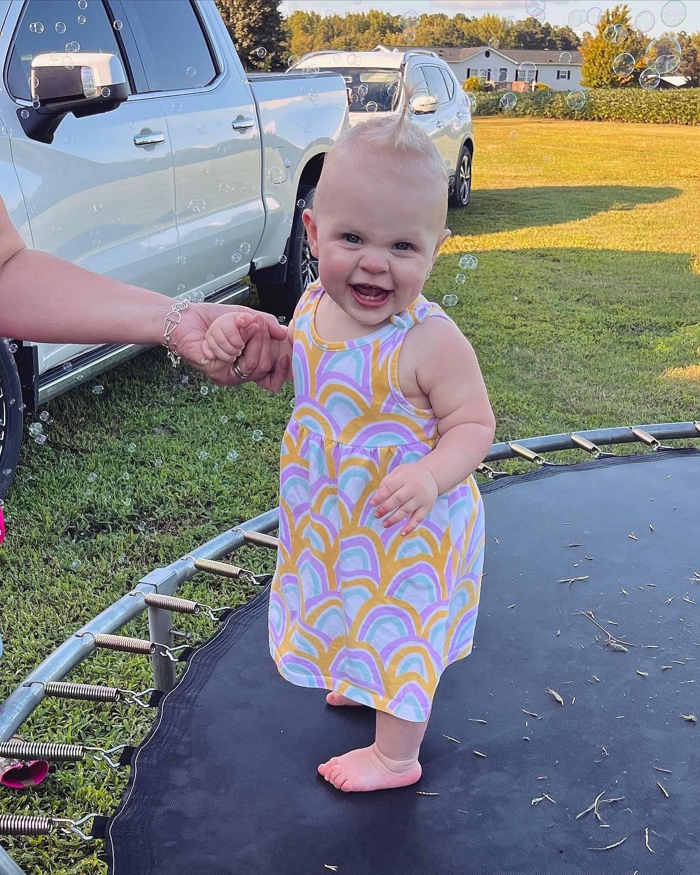 Lilah joined the competition — help win amazing prizes! asphalt, automotive_tire, baby_toddler_clothing, car, fun, grass, happy, leisure, light, motor_vehicle, person, plant, sky, smile, summer, tire, toddler, tree, vehicle, vehicle_door