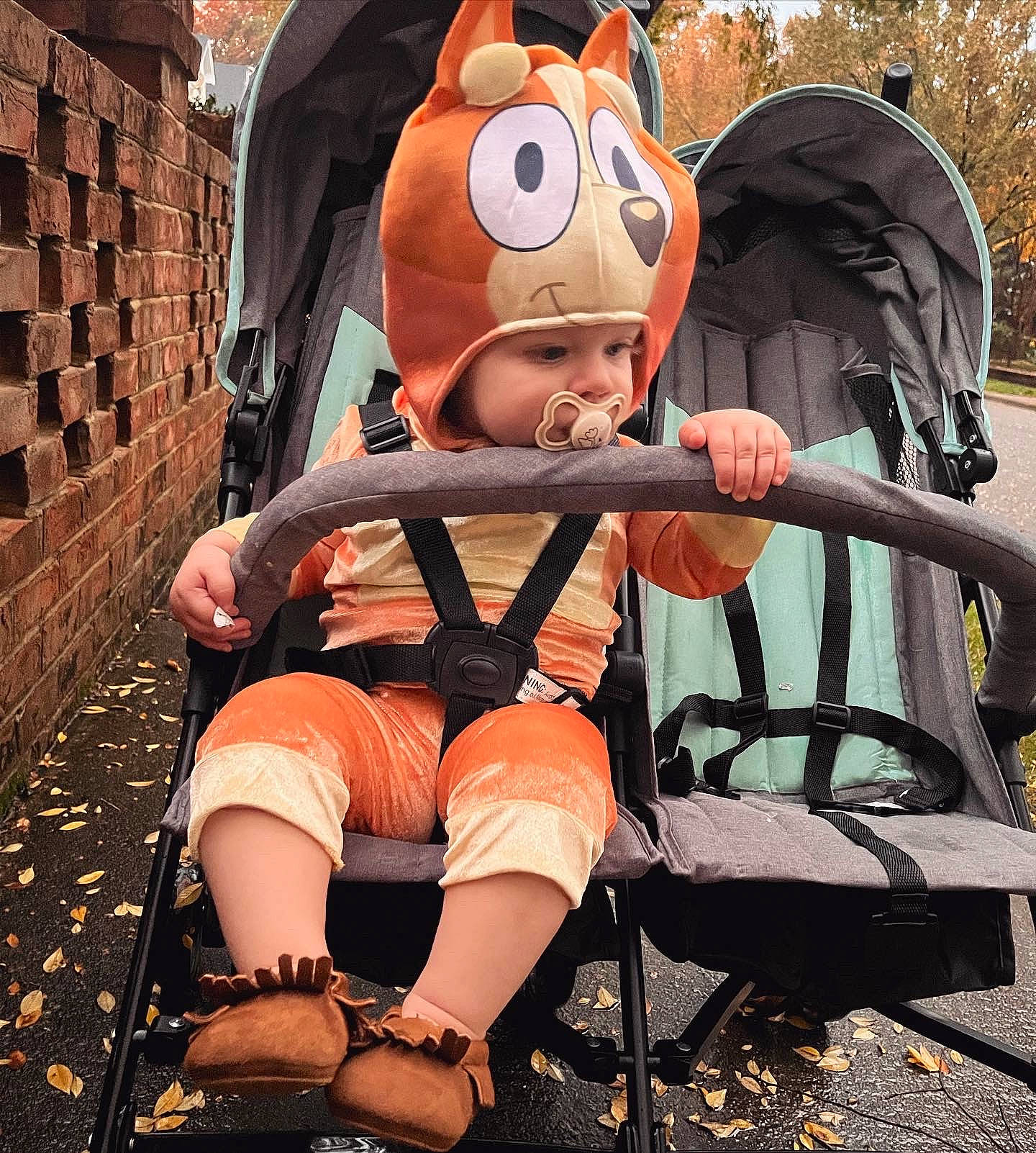 Lilah joined the competition — help win amazing prizes! baby, baby_products, brick, brickwork, child, costume, fun, hat, headwear, human_leg, lap, leisure, mascot, person, personal_protective_equipment, recreation, sandal, shorts, sitting, thigh