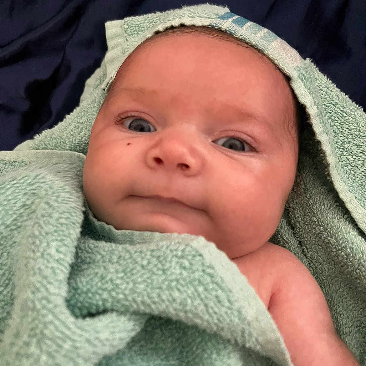Mercy joined the competition — help win amazing prizes! baby, infant, towel, wrapped, face, skin, eyes, portrait, closeup, cute, child, newborn, soft, blanket, expression, head, human, indoors, comfort, warm
