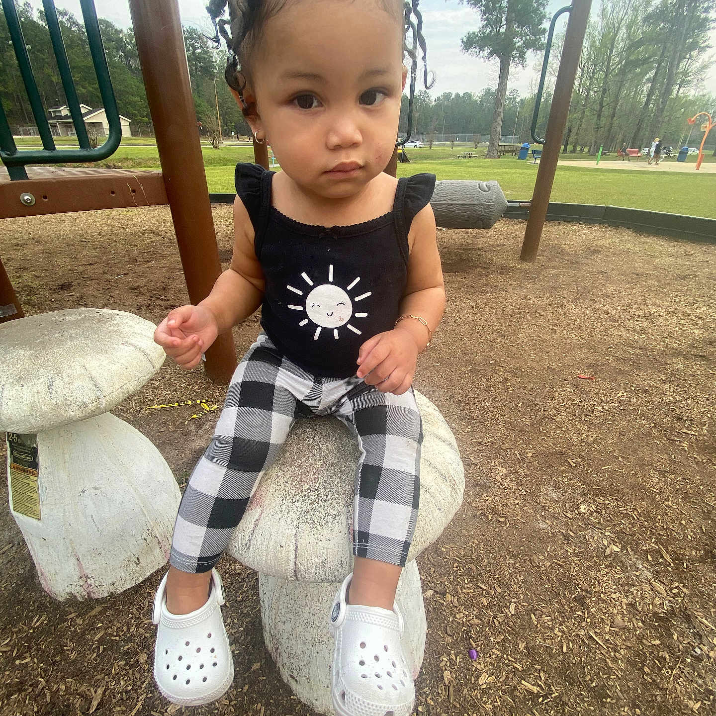 Kailyn is registered to the contest to win money with this photo: baby, car, clothing, face, footwear, grass, head, nature, outdoorplayarea, outdoors, pants, park, person, photography, plant, playarea, portrait, shoe, sitting, tree