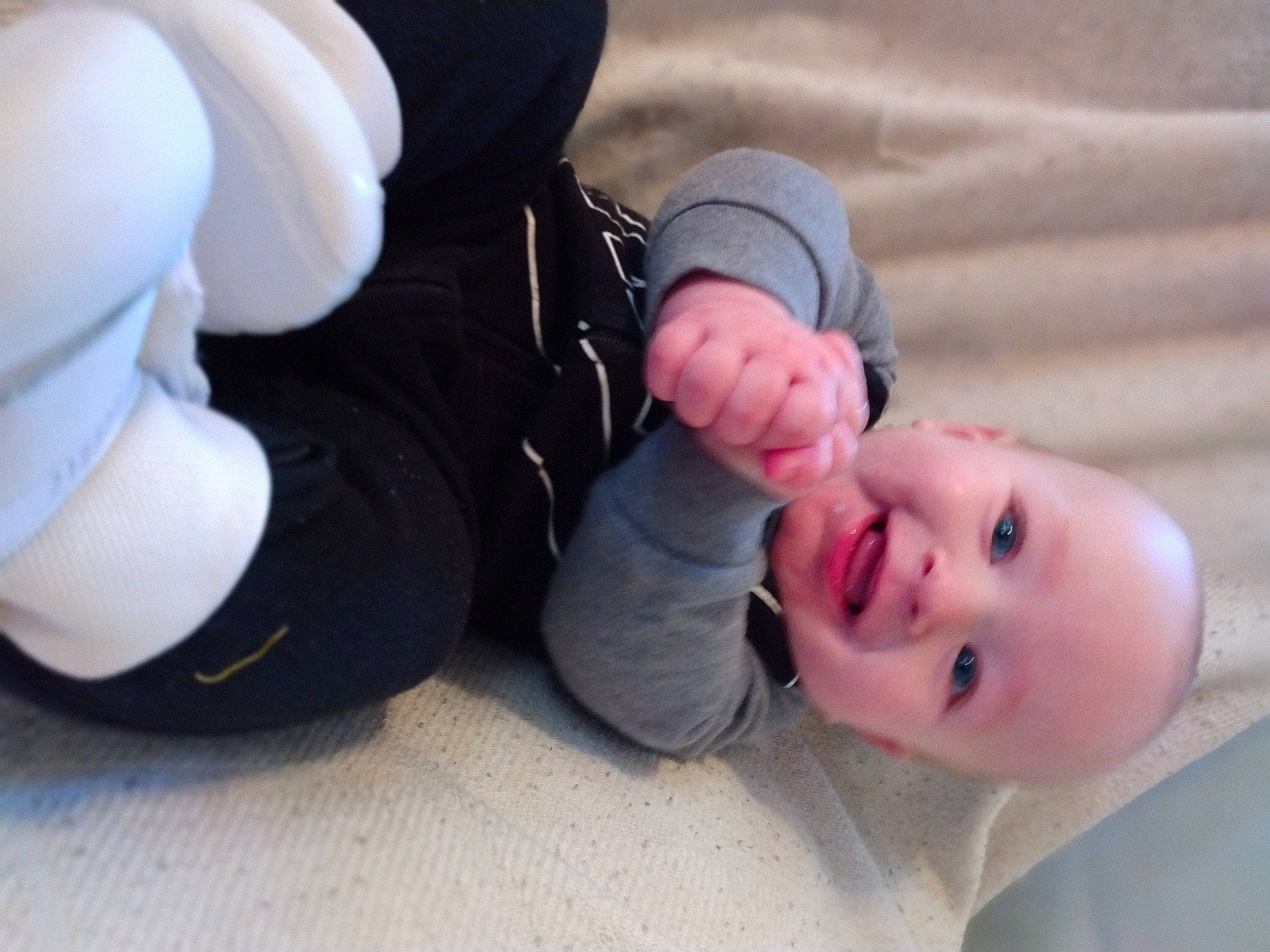 Braidyn is registered to the contest to win money with this photo: arm, baby, baby_toddler_clothing, comfort, eye, finger, flooring, foot, fun, gesture, grass, happy, human_body, joy, knee, leg, mammal, nail, person, smile