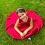 child, girl, smiling, red_dress, headband, grass, outdoor, nature, happy, portrait, sitting, cute, young, fashion, person, greenery, summer, joy, beauty, childhood