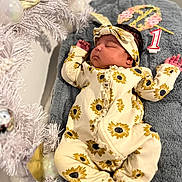 Ibeisy joined the competition — help win amazing prizes! baby, sleeping, onesie, headband, sunflower_pattern, blanket, congratulations, birthday_candle, number_one, christmas_tree, ornaments, silver_balls, gold_ribbon, soft_texture, infant, celebration, holiday_decor, indoor, portrait, cute