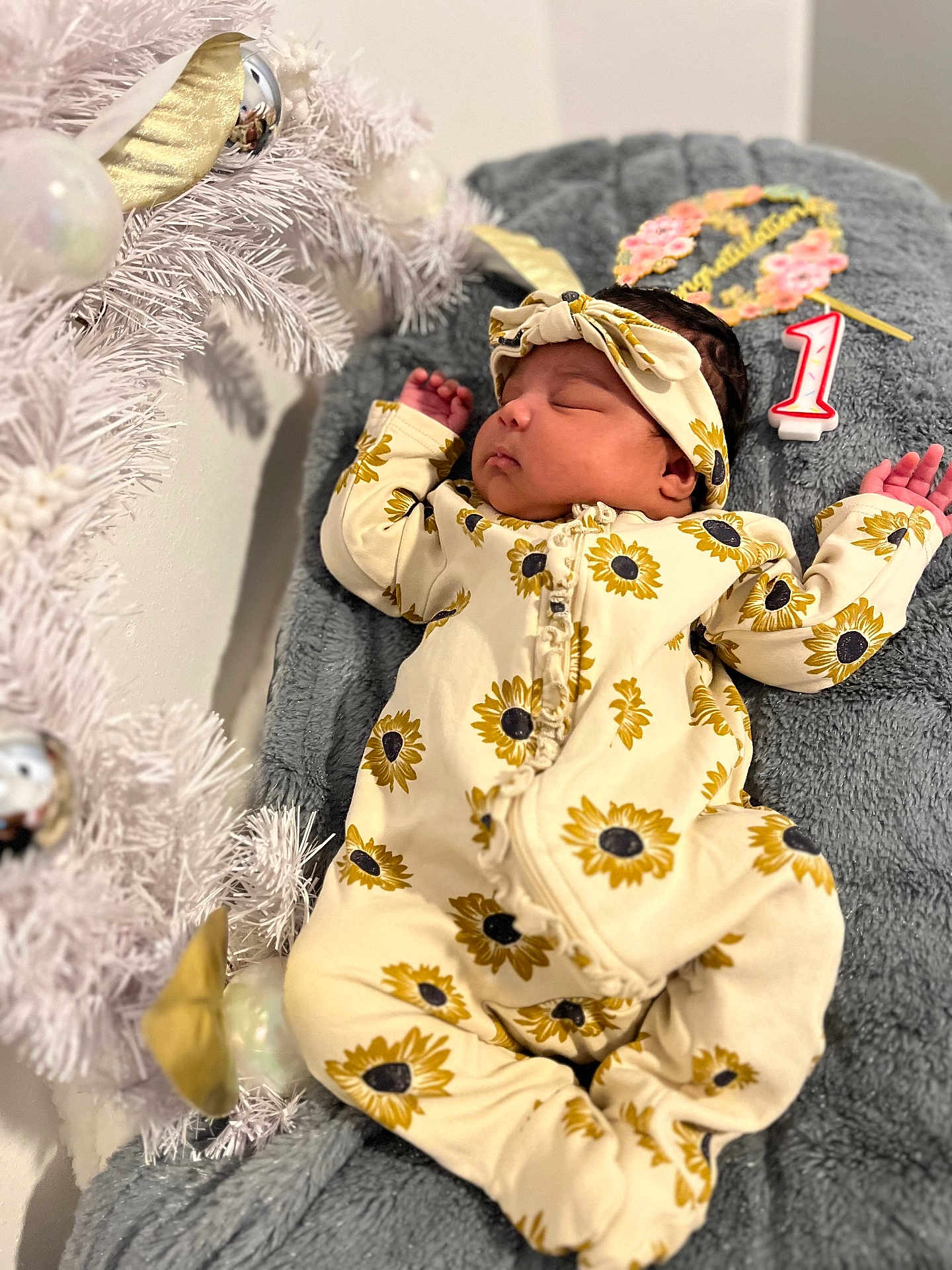 Ibeisy joined the competition — help win amazing prizes! baby, sleeping, onesie, headband, sunflower_pattern, blanket, congratulations, birthday_candle, number_one, christmas_tree, ornaments, silver_balls, gold_ribbon, soft_texture, infant, celebration, holiday_decor, indoor, portrait, cute