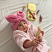 Ainhoa joined the competition — help win amazing prizes! baby, bathrobe, beauty, bed, bedding, blush, bunny_headband, child, cosmetics, cute, eyeshadow, hands, indoor, infant, lying_down, makeup, makeup_brush, pink, portrait, smiling