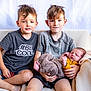 baby, barefoot, blanket, blond_hair, casual_clothing, child, couch, cute, family, happy, holding, indoor, portrait, relaxing, seated, short_hair, siblings, smiling, toddler, young