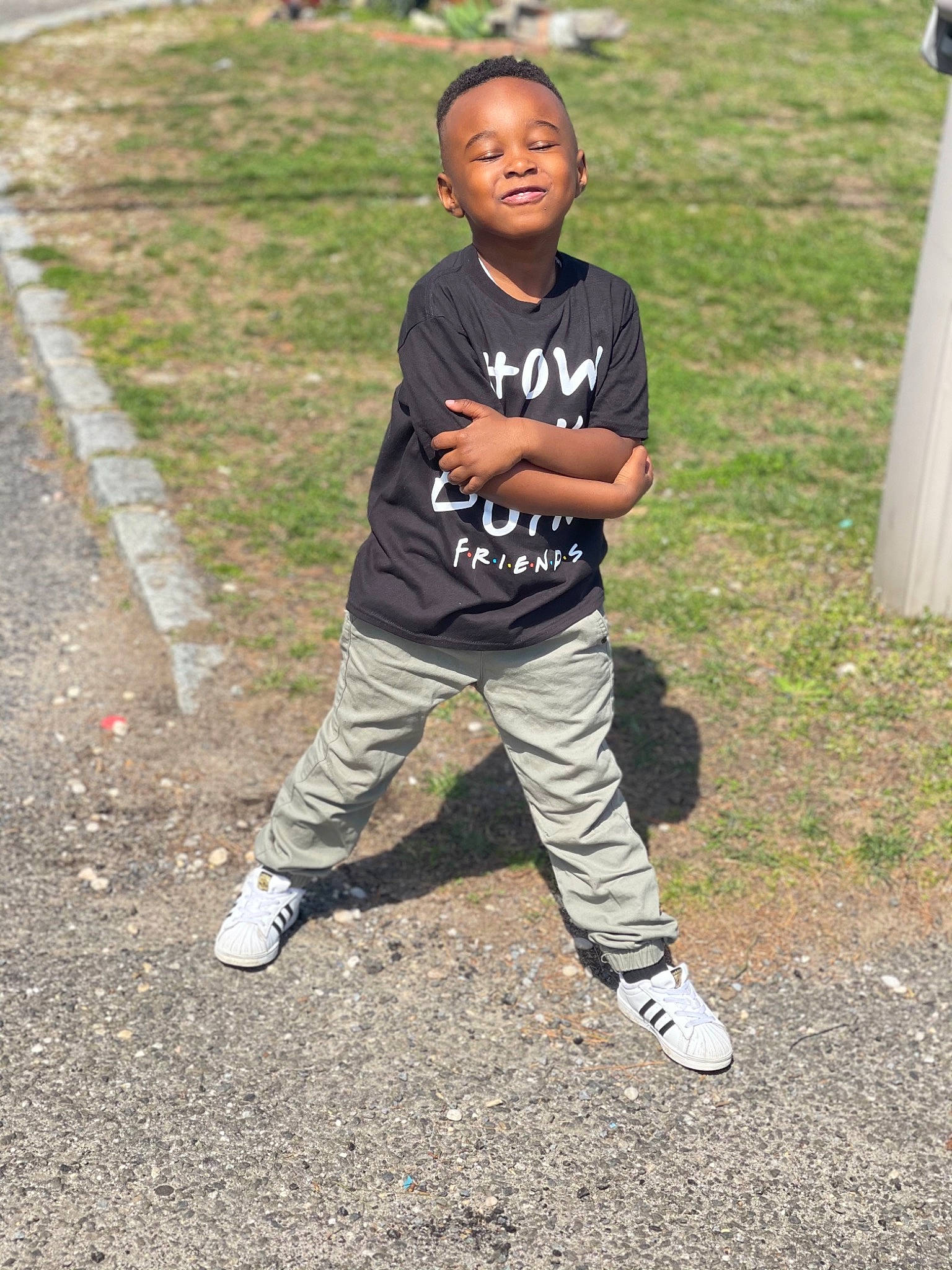 Nasir is registered to the contest to win money with this photo: asphalt, child, fun, grass, hairstyle, happy, joy, knee, leisure, outdoor_shoe, people_in_nature, person, recreation, sleeve, smile, sneakers, sportswear, street_fashion, t_shirt, thigh