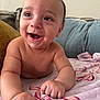 Yea Alexander joined the competition — help win amazing prizes! baby, infant, smiling, bare_chest, blanket, couch, pillow, living_room, floral_blanket, hands, fingers, eyes, mouth, tooth, cheek, skin, closeup, portrait, happy, playful