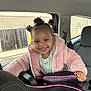 Gracelynn joined the competition — help win amazing prizes! toddler, child, smile, car, car_seat, jacket, pink, hair_buns, happy, interior, window, seatbelt, person, cute, baby, face, clothing, vehicle, seat, portrait