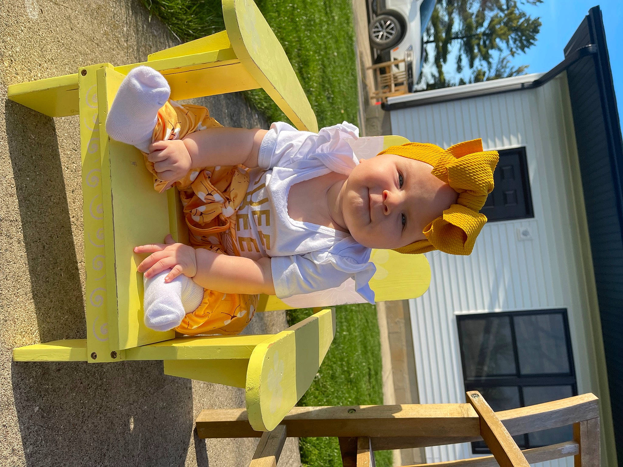 Yvette is registered to the contest to win money with this photo: baby, baby_toddler_clothing, building, chair, child, fun, happy, hat, headwear, house, leisure, outdoor_furniture, person, play, recreation, shorts, smile, toddler, tree, vacation