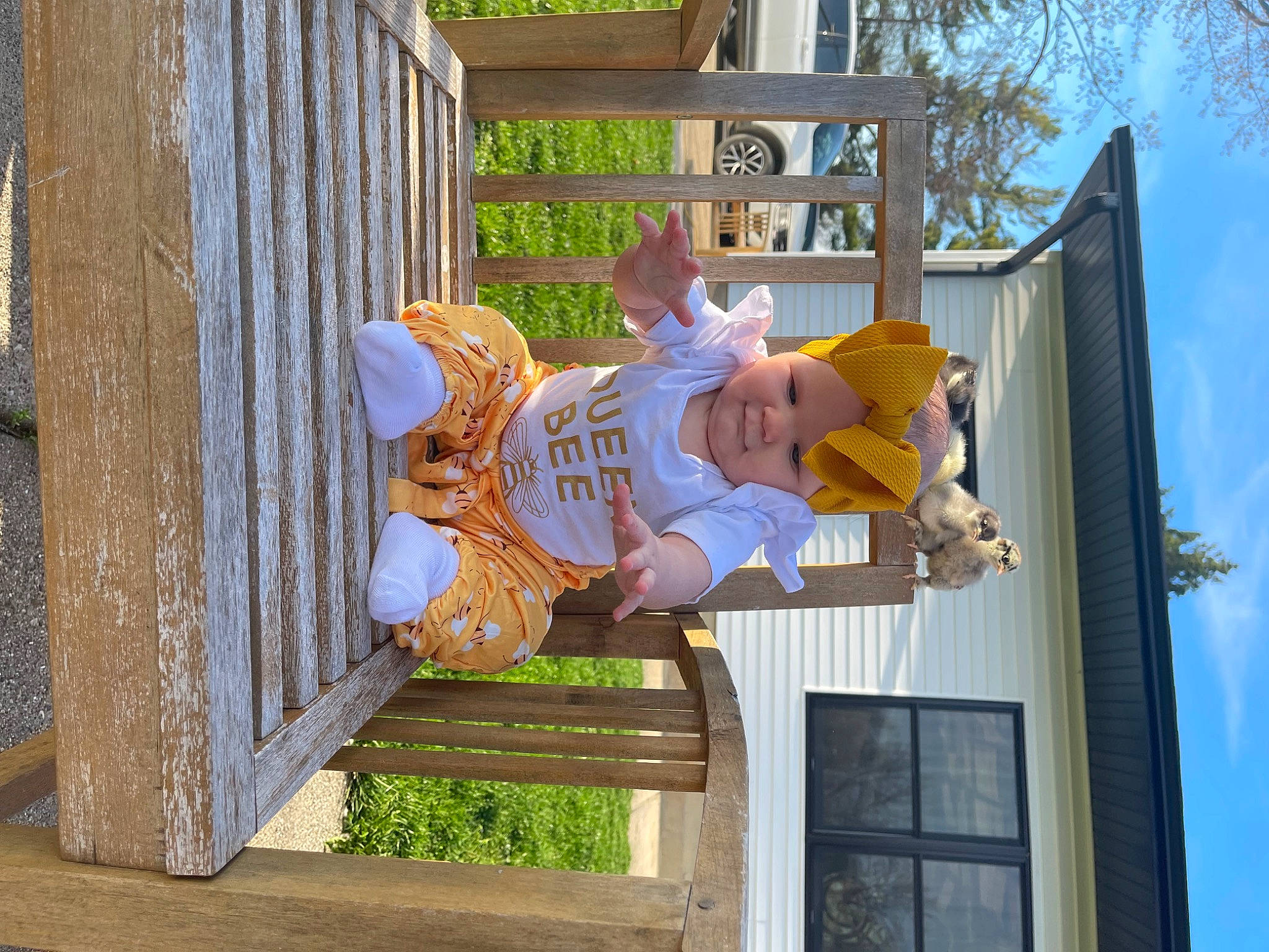 Yvette is registered to the contest to win money with this photo: child, door, facade, fun, happy, hat, headwear, house, leisure, person, plant, siding, sky, toddler, tree, vacation, window, wood