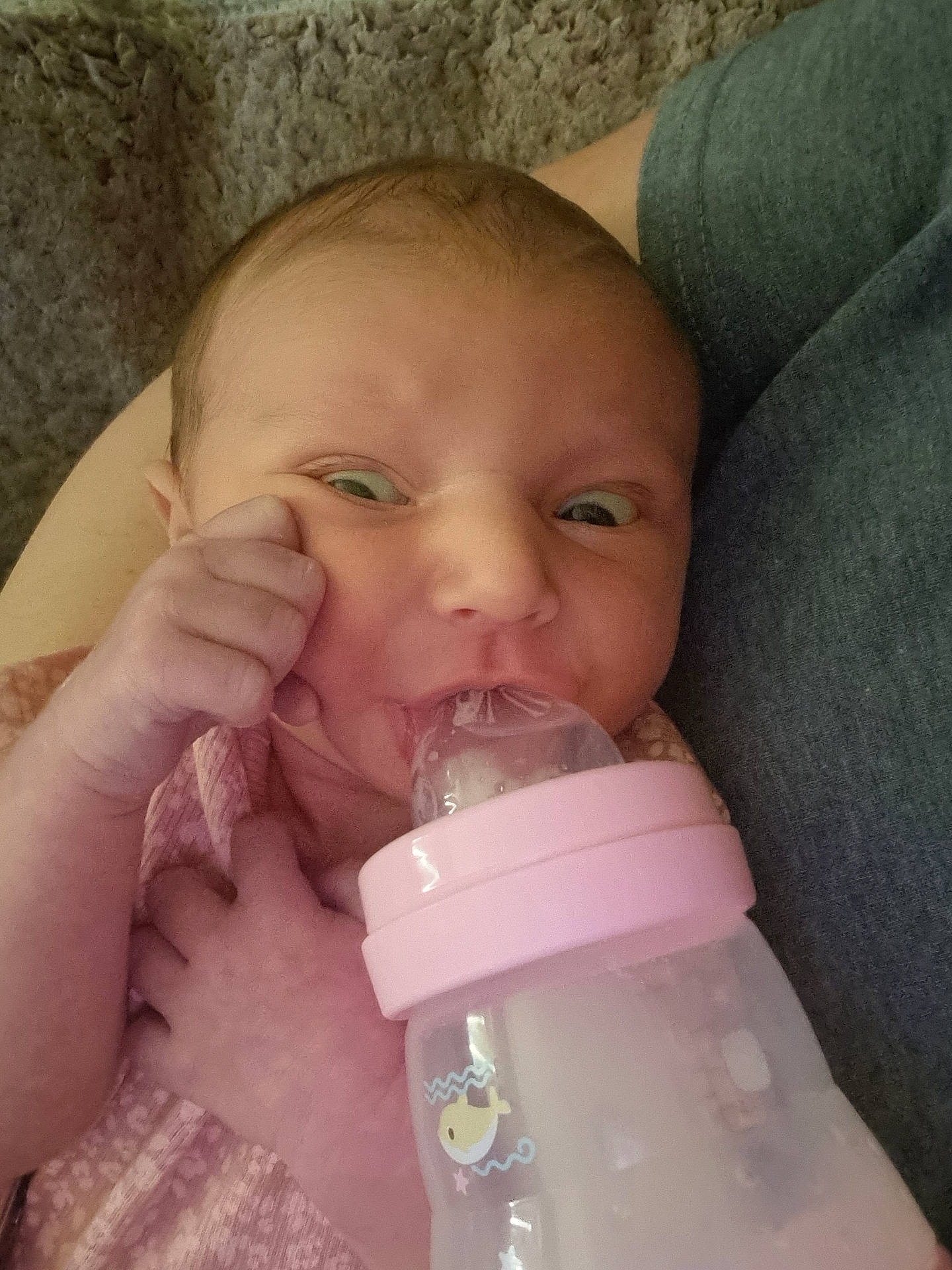 Aria is registered to the contest to win money with this photo: baby, beverage, bodypart, bottle, couch, drinking, face, finger, furniture, hand, head, medication, milk, newborn, person, photography, pill, portrait, tape, waterbottle