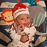 baby, child, infant, smiling, christmas, santa_hat, festive, portrait, indoor, baby_bouncer, animal_pattern, elephant, lion, mouse, colorful, seated, onesie, happy, holiday, close_up