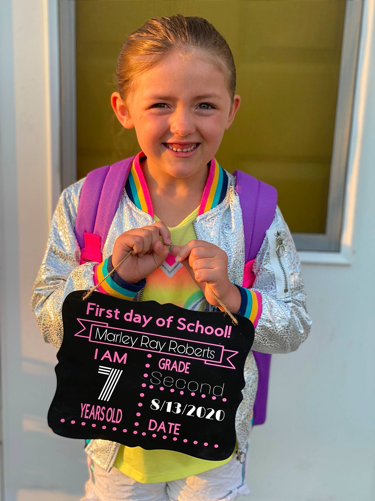 Marley is registered to the contest to win money with this photo: baby_toddler_clothing, child, event, face, fashion_design, fun, gesture, hairstyle, happy, human_body, joy, magenta, neck, pattern, person, pink, sleeve, smile, t_shirt, thumb