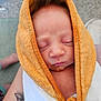 baby, sleeping, towel, orange, white, closeup, wrapped, infant, skin, face, peaceful, cozy, tattoo, leg, carpet, indoor, cute, newborn, person, portrait