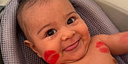 Maximiliano is registered to the contest to win money with this photo: baby, infant, smiling, face, kiss_marks, red_lipstick, bathtub, bath_seat, water_drops, skin, cheeks, eyes, mouth, tongue, shoulders, chest, happy, cute, closeup, indoors