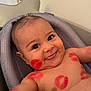 baby, infant, smiling, face, kiss_marks, red_lipstick, bathtub, bath_seat, water_drops, skin, cheeks, eyes, mouth, tongue, shoulders, chest, happy, cute, closeup, indoors