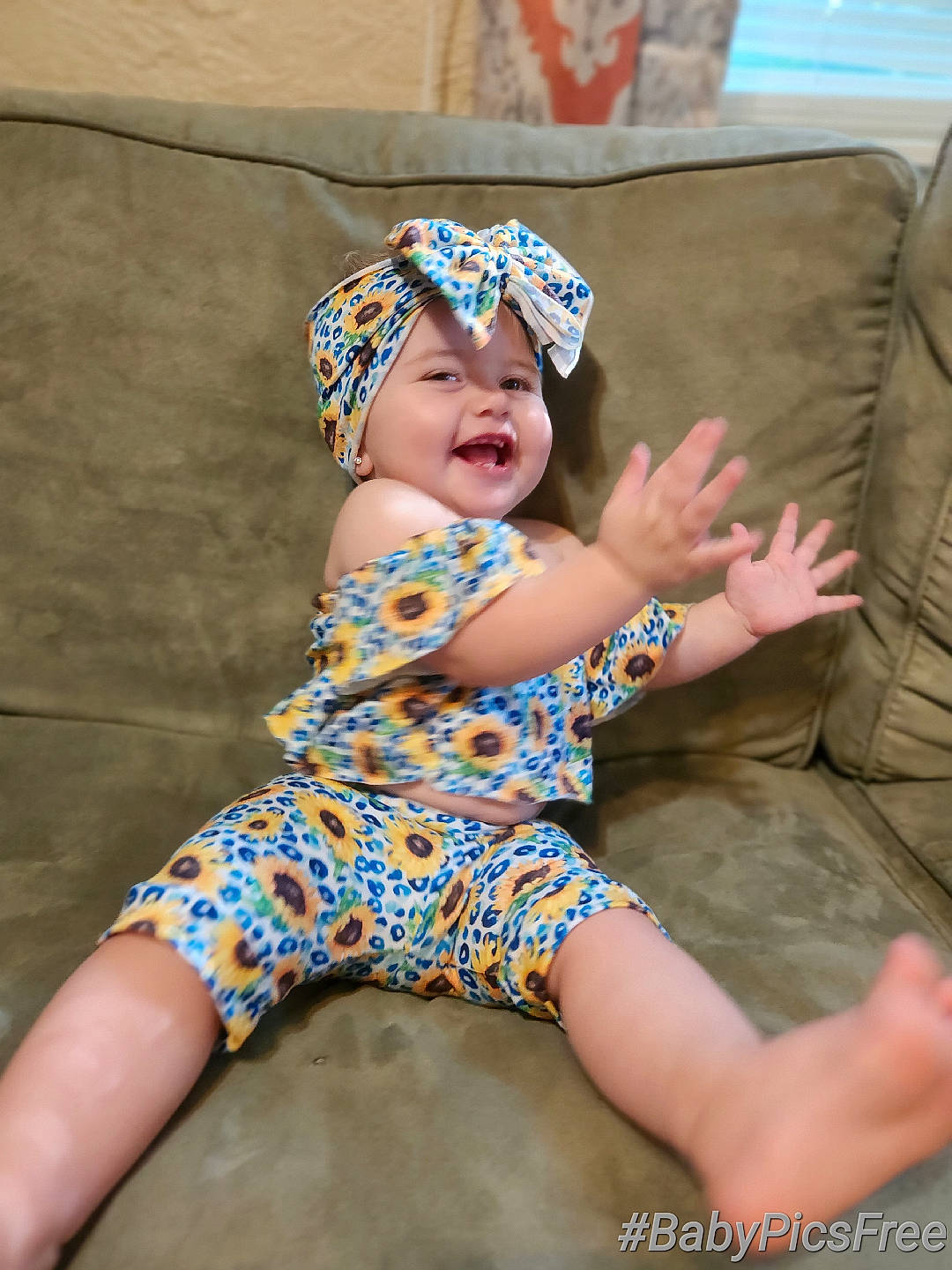 Cecilia is registered to the contest to win money with this photo: baby_toddler_clothing, barefoot, cap, child, comfort, couch, electric_blue, fashion_accessory, finger, foot, fun, happy, headwear, human_leg, leg, person, personal_protective_equipment, pink, sitting, smile