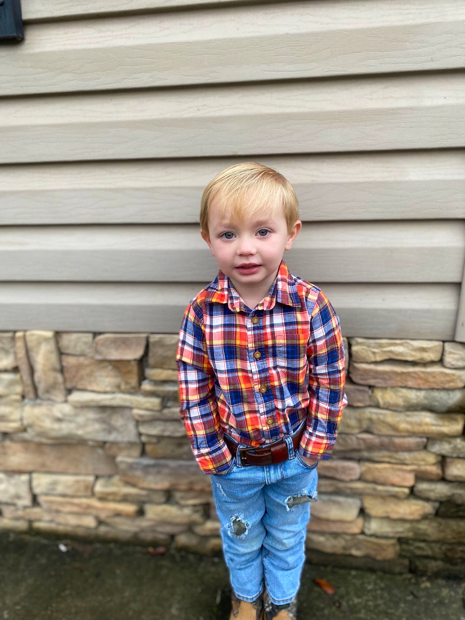 Benton joined the competition — help win amazing prizes! blond, brick, denim, dress_shirt, electric_blue, face, happy, jeans, orange, pattern, person, plaid, sleeve, smile, standing, street_fashion, t_shirt, tartan, toddler, wall