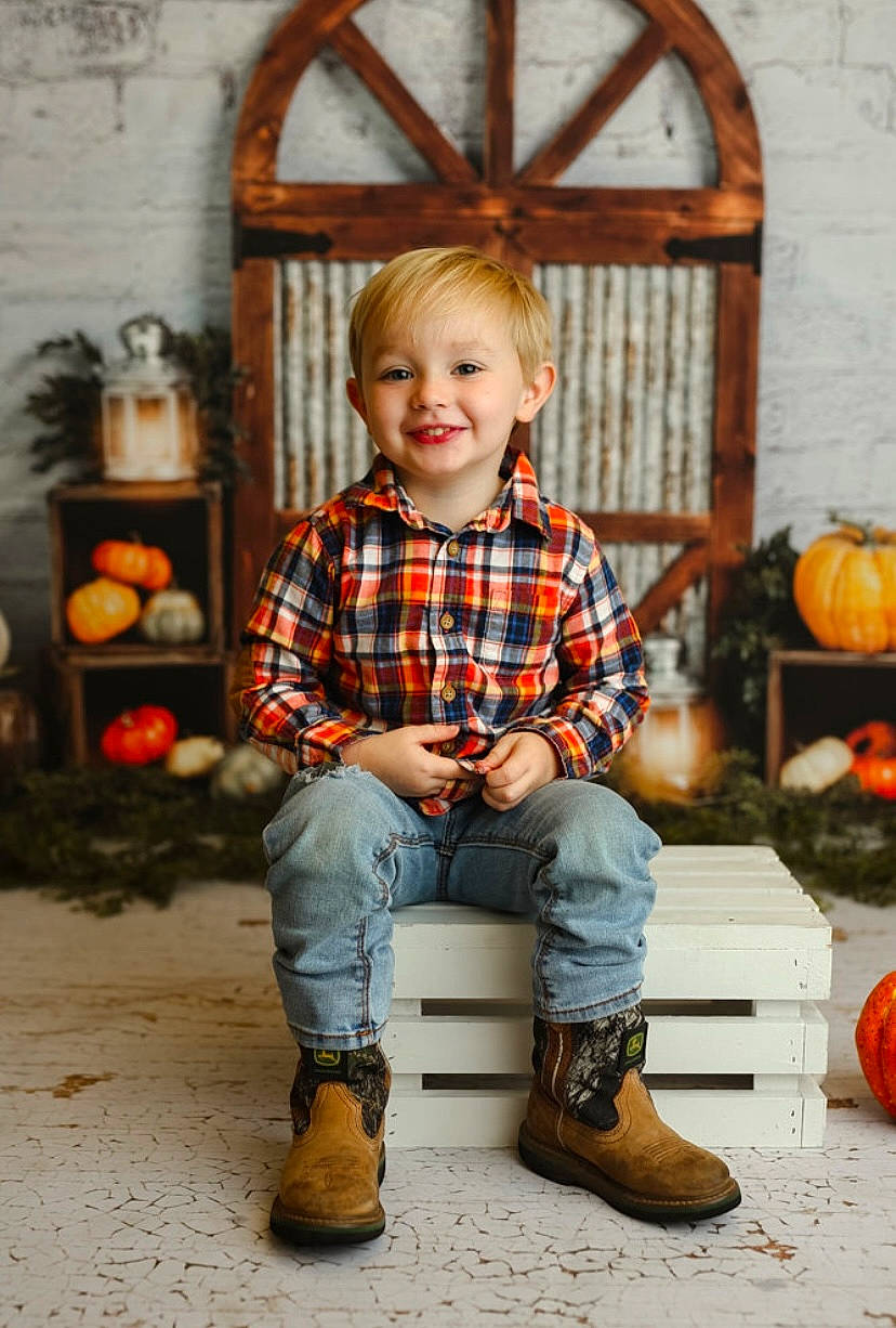 Benton is registered to the contest to win money with this photo: baby_toddler_clothing, calabaza, chair, face, flash_photography, footwear, hairstyle, happy, head, human_body, jeans, joy, orange, person, plaid, pumpkin, shoe, sleeve, smile, standing