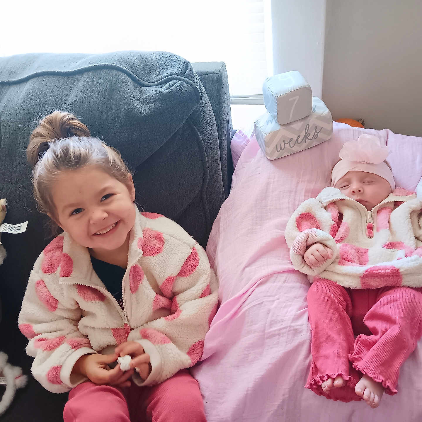 Remi And Addie is registered to the contest to win money with this photo: baby, babylaughing, blanket, child, couch, cushion, face, family, female, furniture, girl, happy, head, homedecor, people, person, photography, pillow, portrait, smile