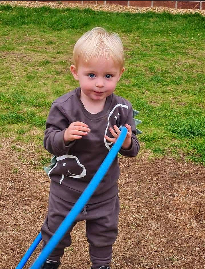 Oliver is registered to the contest to win money with this photo: arbor_day, baby, child, electric_blue, fun, garden_tool, gardener, gardening, grass, lawn, outdoor_play_equipment, people_in_nature, person, plant, play, recreation, soil, spring, t_shirt, toddler