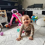 Maeva a rejoint le concours — aidez-le/la à gagner de superbes lots ! baby, child, colorful, crawling, cushions, cute, elephant_toy, floor, happy, indoor, infant, living_room, pajamas, person, plastic_toys, playmat, smiling, toys, walker, wooden_toy