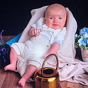 Lyssandre a rejoint le concours — aidez-le/la à gagner de superbes lots ! baby, infant, blanket, flowers, purple_flowers, blue_flowers, watering_can, wooden_floor, white_clothing, soft_texture, indoor, portrait, cute, relaxed, decor, pot, plant, baby_boy, sitting, expression