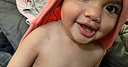 Kamila joined the competition — help win amazing prizes! toddler, child, smile, face, pink_towel, hood, indoor, couch, blanket, baby_lotion, happy, skin, person, closeup, baby, young_child, expression, cute, sitting, room