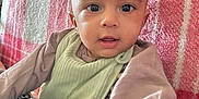 Ibrahim is registered to the contest to win money with this photo: baby, infant, child, face, eyes, hand, couch, blanket, pillow, indoor, clothing, curious, expression, portrait, young, sitting, soft, comfort, home, closeup