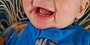 Jasper is registered to the contest to win money with this photo: baby, smiling, blue_onesie, animal_print, face, infant, child, happy, cute, patterned_blanket, cozy, portrait, skin, head, mouth_open, teeth, cheeks, eyes, person, lying_down