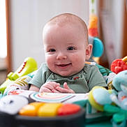 Jasper joined the competition — help win amazing prizes! baby, smiling, child, infant, toy, activity_center, colorful, happy, playful, indoor, person, clothing, seat, cute, young, hands, face, head, expression, early_childhood