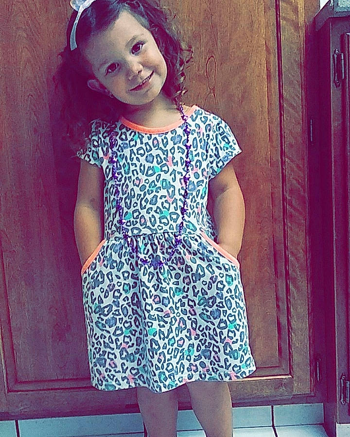 Elia is registered to the contest to win money with this photo: beauty, blue, child, clothing, cool, day_dress, design, dress, fashion, head, headgear, joint, joy, pattern, person, pink, purple, shoulder, smile, toddler